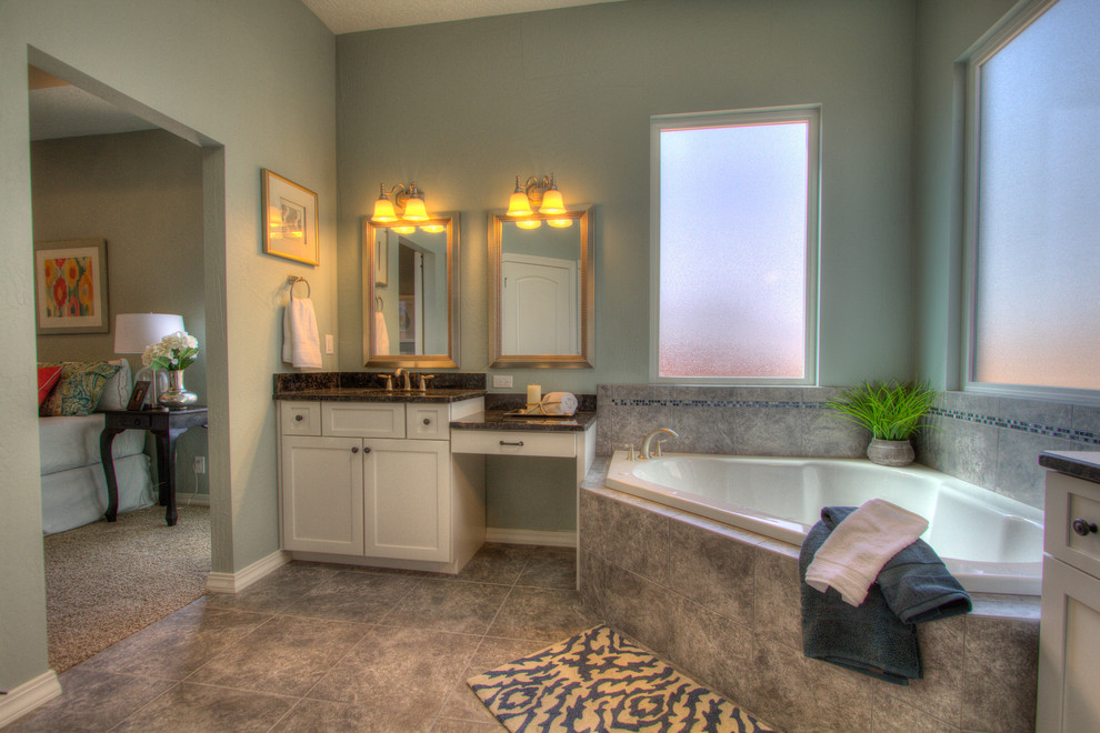 Design ideas for a large traditional master bathroom in Albuquerque with an undermount sink, shaker cabinets, white cabinets, granite benchtops, a corner tub, gray tile, porcelain tile, blue walls, porcelain floors, a curbless shower and a two-piece toilet.