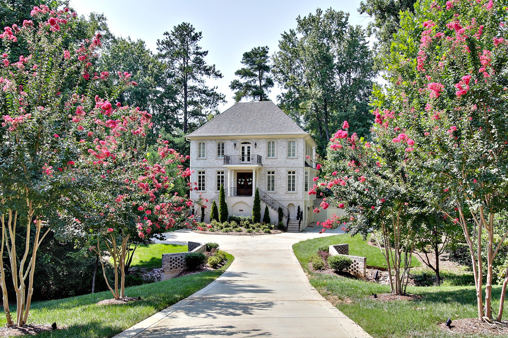 Photo of a traditional three-storey beige exterior in Raleigh.