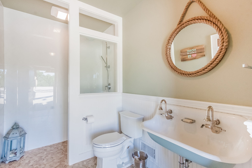 Design ideas for a mid-sized beach style 3/4 bathroom in Boston with a trough sink, an open shower, a two-piece toilet, white tile, beige walls, an open shower, pebble tile floors and multi-coloured floor.