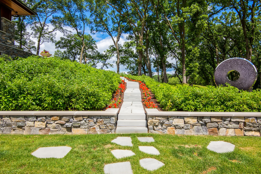 Photo of a mid-sized craftsman full sun backyard stone garden path in Minneapolis for summer.