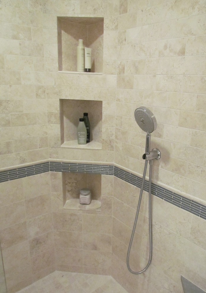This is an example of a transitional bathroom in Chicago with an undermount sink, flat-panel cabinets, dark wood cabinets, engineered quartz benchtops, a corner shower, beige tile, stone tile and travertine floors.