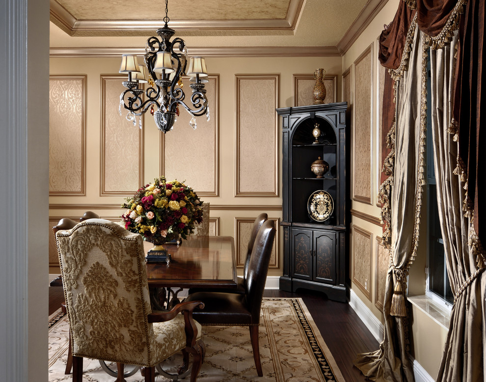 This is an example of a traditional separate dining room in Miami with beige walls and dark hardwood floors.