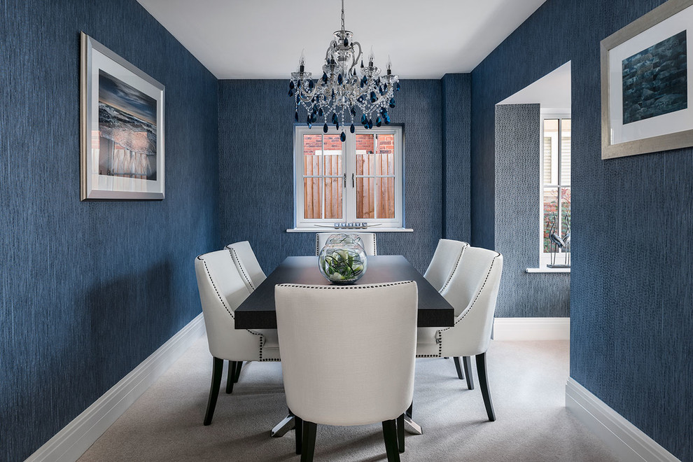 This is an example of a transitional separate dining room in Berkshire with blue walls, carpet and beige floor.
