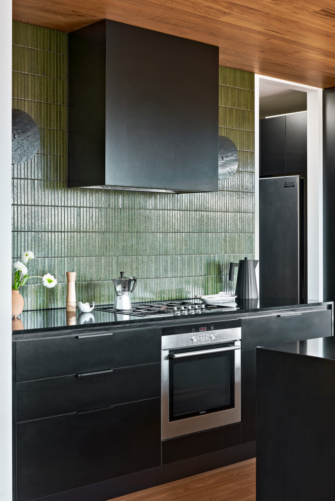 Inspiration for a large contemporary eat-in kitchen in Melbourne with black cabinets and with island.