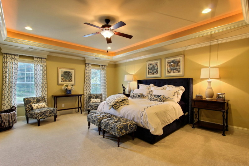 Photo of a large traditional master bedroom in Atlanta with yellow walls, ceramic floors and no fireplace.
