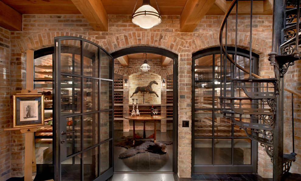 This is an example of a transitional wine cellar in Chicago with storage racks and black floor.