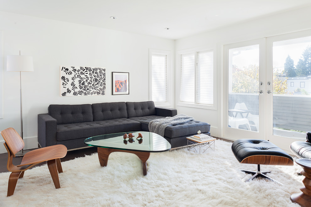 Photo of a transitional formal enclosed living room in Vancouver with white walls and dark hardwood floors.