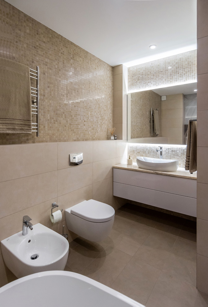 Inspiration for a contemporary master bathroom in Novosibirsk with flat-panel cabinets, white cabinets, a freestanding tub, a bidet, beige tile, mosaic tile, a vessel sink, beige floor and beige benchtops.