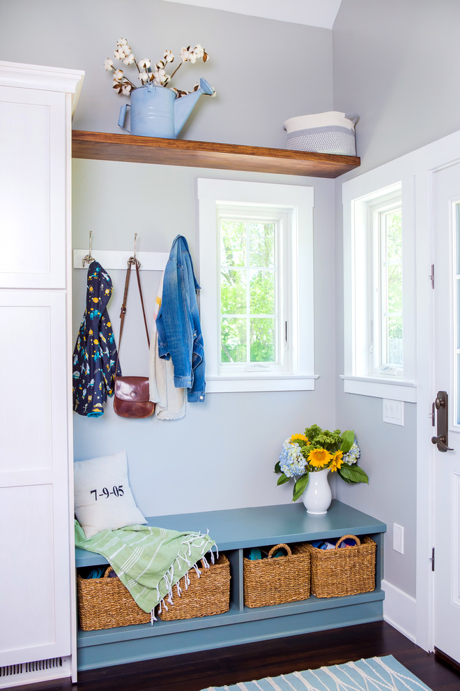 This is an example of a small traditional mudroom in Other with grey walls, dark hardwood floors, brown floor, a single front door and a white front door.