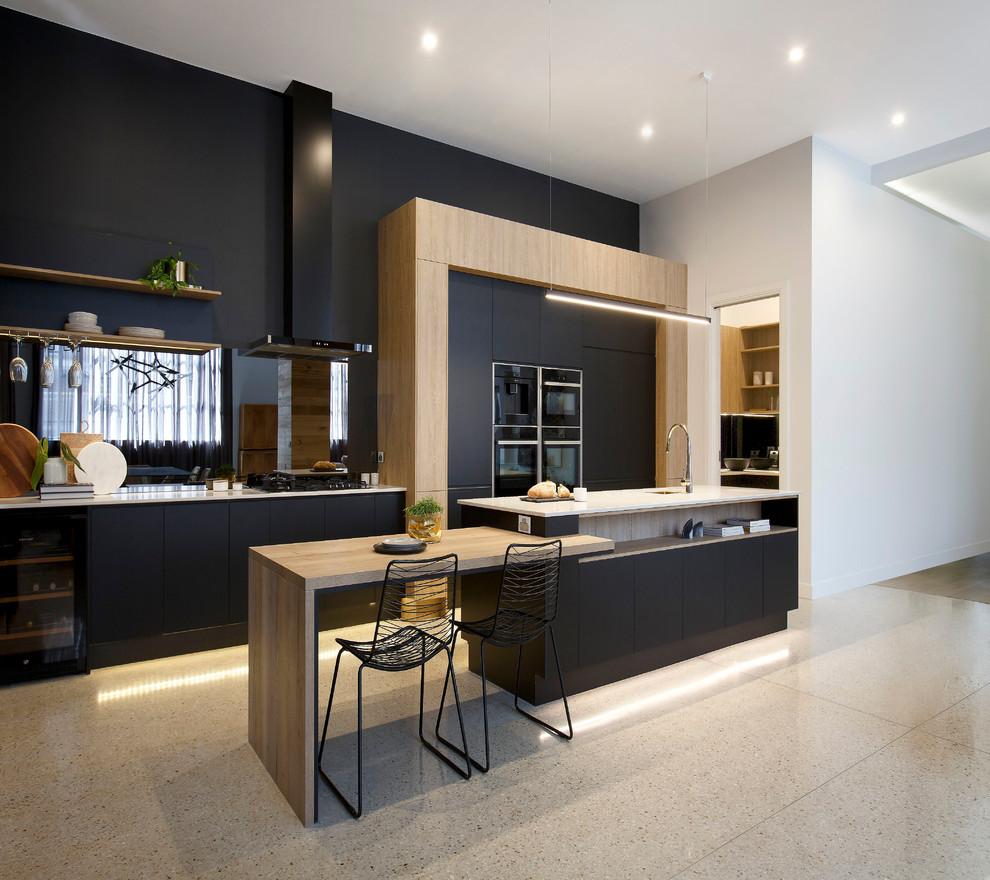 Photo of a large modern galley kitchen pantry in Melbourne with a single-bowl sink, black cabinets, quartz benchtops, metallic splashback, mirror splashback, black appliances and with island.