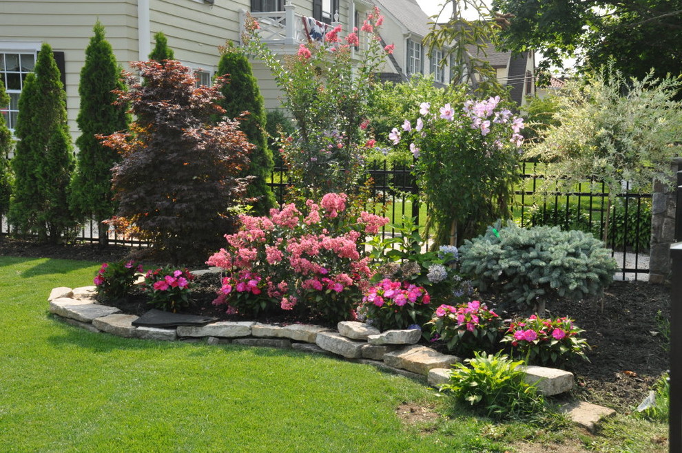 Transitional front yard garden in New York with a garden path and natural stone pavers.