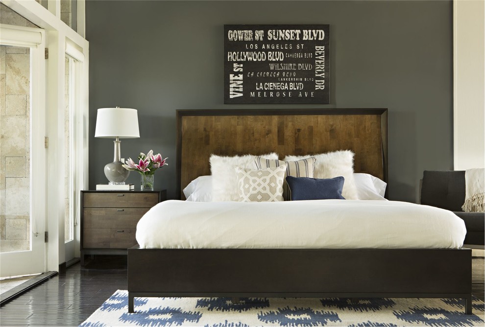 Design ideas for a mid-sized modern guest bedroom in Los Angeles with grey walls, dark hardwood floors and no fireplace.