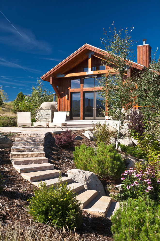 Inspiration for a contemporary sloped garden in Other with natural stone pavers.