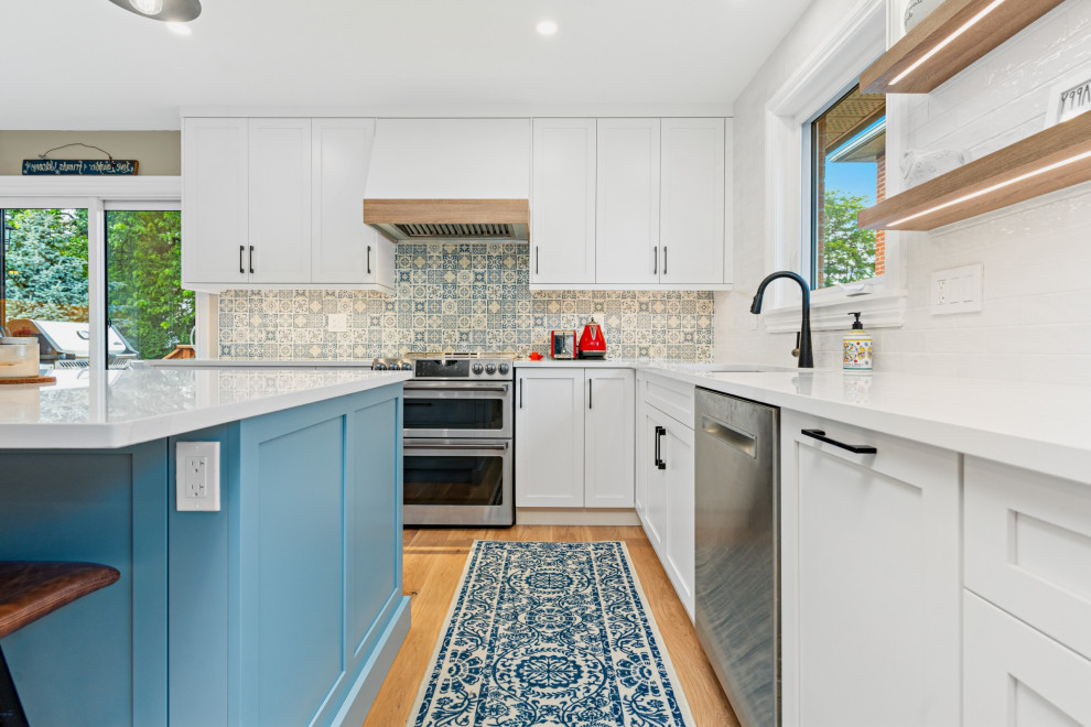Design ideas for a medium sized l-shaped kitchen/diner in DC Metro with a submerged sink, shaker cabinets, blue cabinets, engineered stone countertops, blue splashback, porcelain splashback, stainless steel appliances, medium hardwood flooring, yellow floors and white worktops.