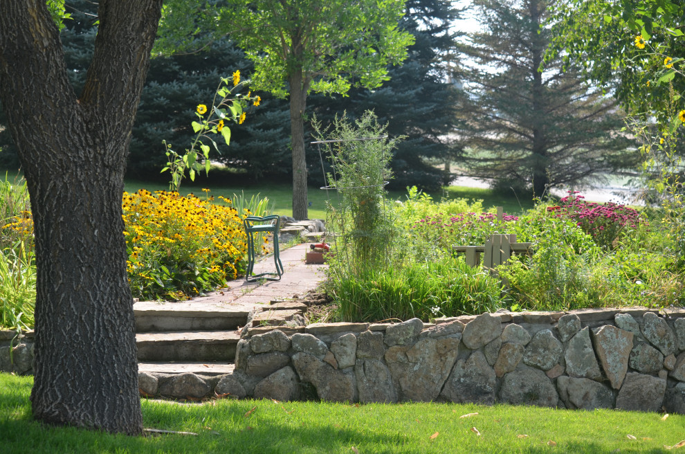 Pollinator garden with native plants and custom stone hardscapes