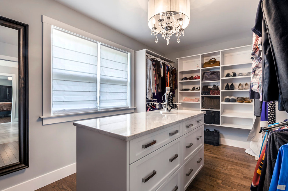 Walk-in closet - large transitional gender-neutral medium tone wood floor walk-in closet idea with shaker cabinets and white cabinets