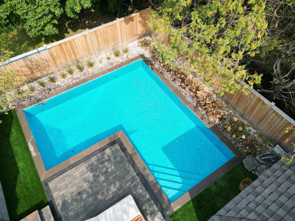 Backyard l-shaped pool landscaping photo in Ottawa