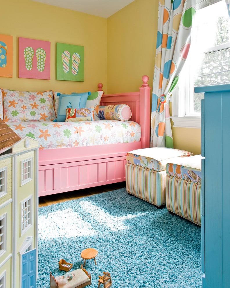 Photo of a large traditional kids' room for girls in Boston with yellow walls and carpet.