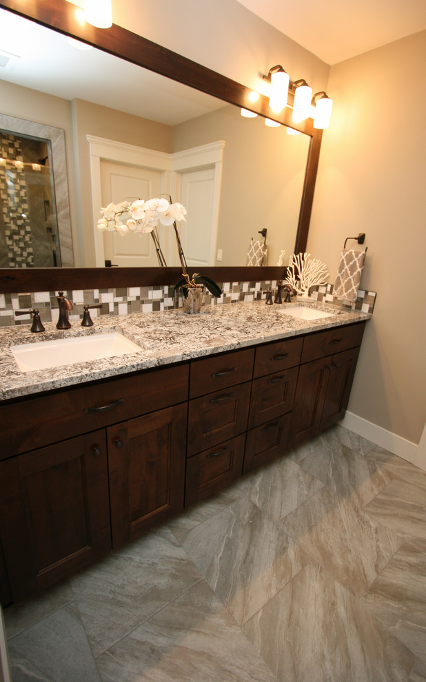 Mid-sized mountain style kids' beige tile and porcelain tile porcelain tile home design photo in Seattle with shaker cabinets, dark wood cabinets, a two-piece toilet, beige walls, an undermount sink and granite countertops