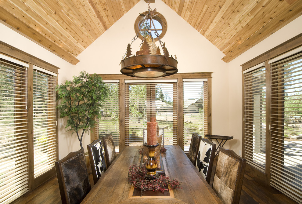 Country dining room in Other with white walls and dark hardwood floors.