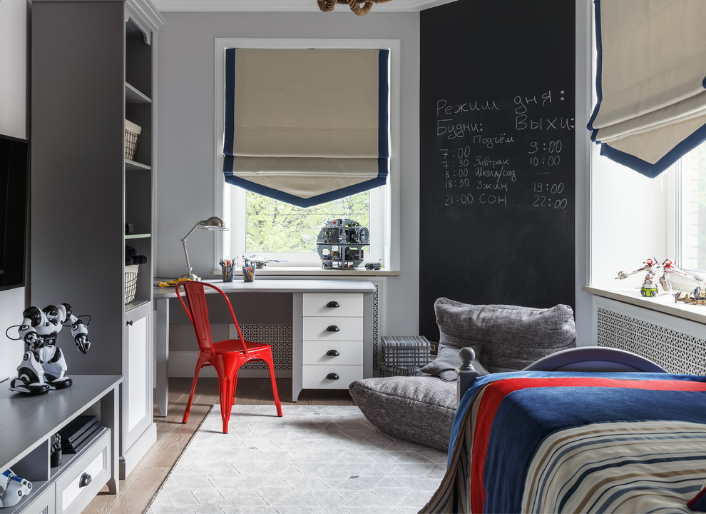 This is an example of a transitional kids' room for boys in Other with grey walls and light hardwood floors.