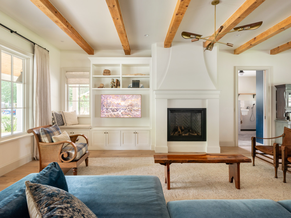 Ramsey House - Living room - farmhouse medium tone wood floor, brown floor and exposed beam living room idea in Austin with white walls, a standard fireplace and a wall-mounted tv