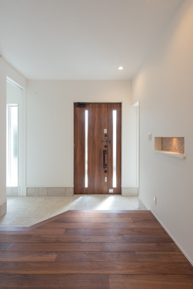 Inspiration for a mid-sized modern entry hall in Other with white walls, dark hardwood floors, a single front door, a dark wood front door, brown floor, wallpaper and wallpaper.
