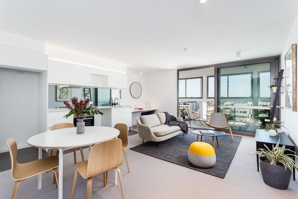 Contemporary open concept living room in Perth with white walls and beige floor.