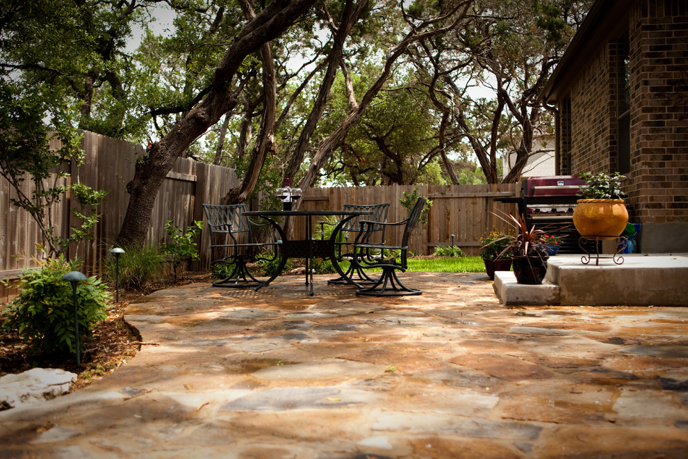 Design ideas for a small traditional backyard patio in Austin with natural stone pavers and no cover.