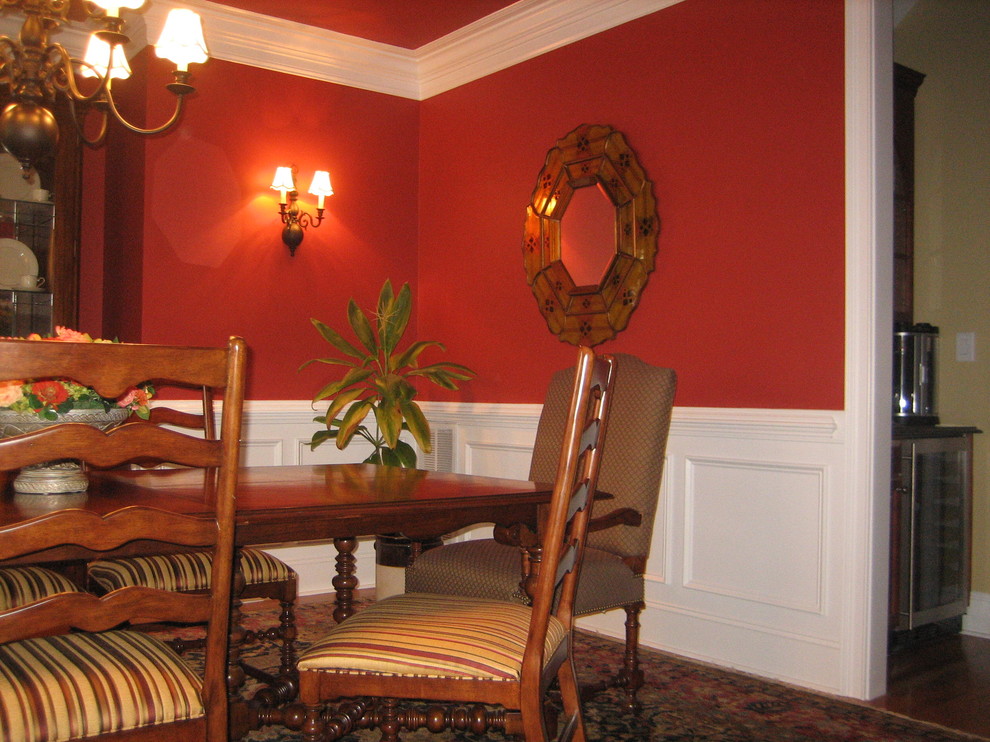 Photo of a mid-sized traditional enclosed family room in Raleigh with red walls and no tv.