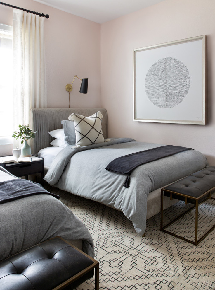 Photo of a mid-sized transitional guest bedroom in Austin with pink walls, carpet, no fireplace and grey floor.