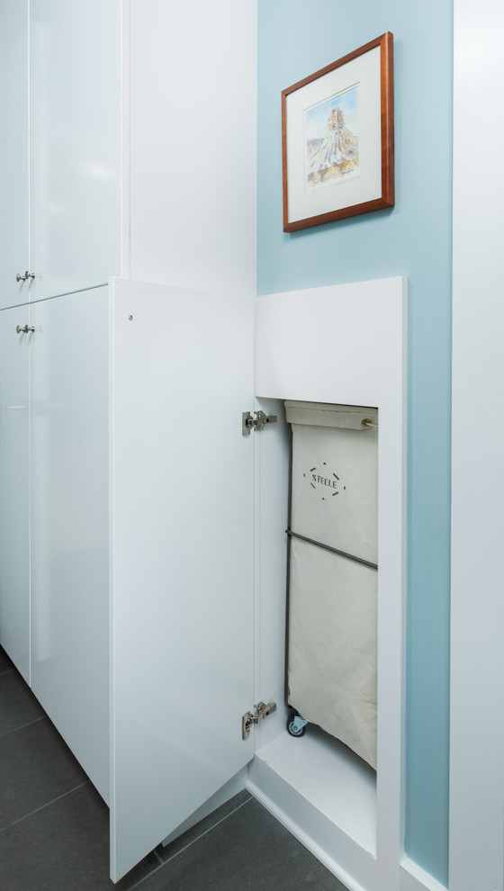 Small midcentury u-shaped dedicated laundry room in Other with flat-panel cabinets, white cabinets, laminate benchtops, blue walls, porcelain floors, a side-by-side washer and dryer, grey floor and white benchtop.