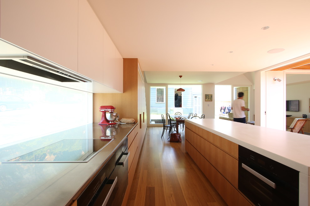 Design ideas for a contemporary kitchen in Sydney with with island and medium wood cabinets.