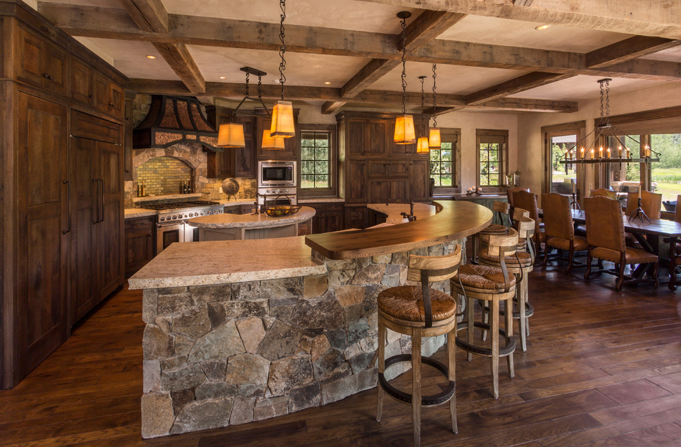 Large mountain style single-wall medium tone wood floor eat-in kitchen photo in Denver with a farmhouse sink, shaker cabinets, medium tone wood cabinets, granite countertops, multicolored backsplash, stone tile backsplash, stainless steel appliances and an island