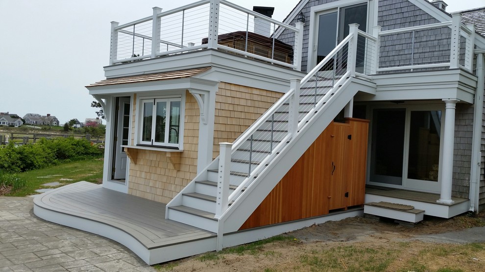 Inspiration for a small beach style two-storey grey house exterior in Boston with wood siding, a gable roof and a shingle roof.