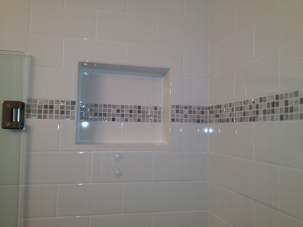 This is an example of a mid-sized traditional 3/4 bathroom in Miami with an alcove shower, a one-piece toilet, white tile, subway tile, white walls, porcelain floors, brown floor and a hinged shower door.