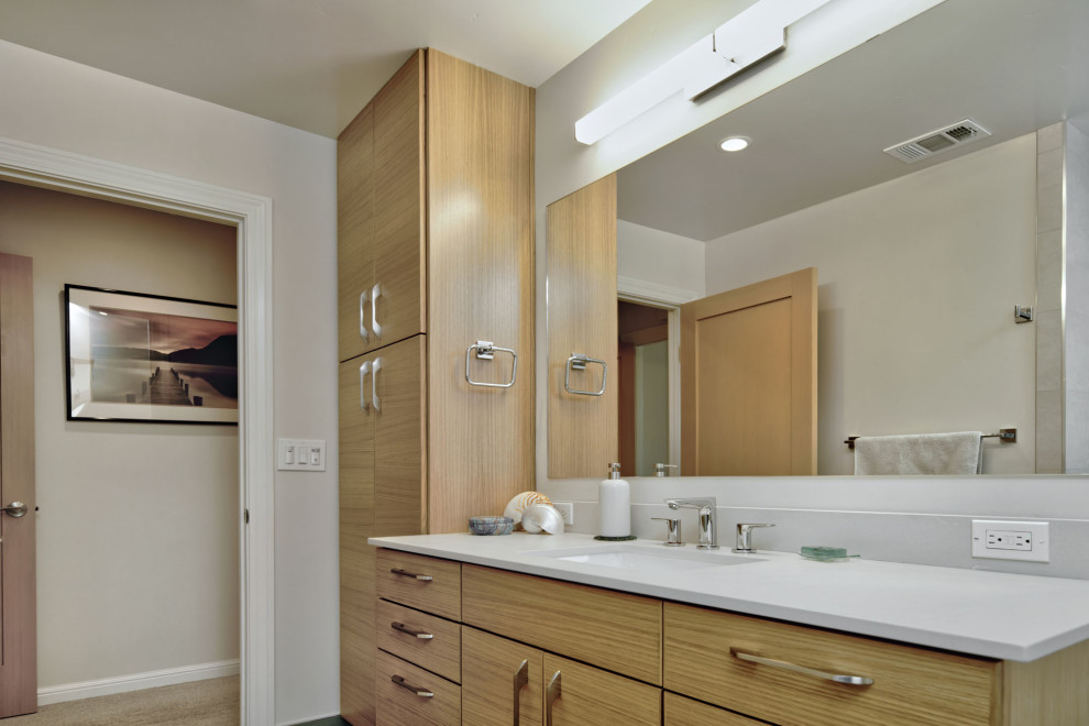Photo of a medium sized contemporary bathroom in San Francisco with light wood cabinets, beige tiles, ceramic tiles, beige walls, porcelain flooring, a submerged sink, engineered stone worktops, green floors, white worktops, a single sink and a floating vanity unit.