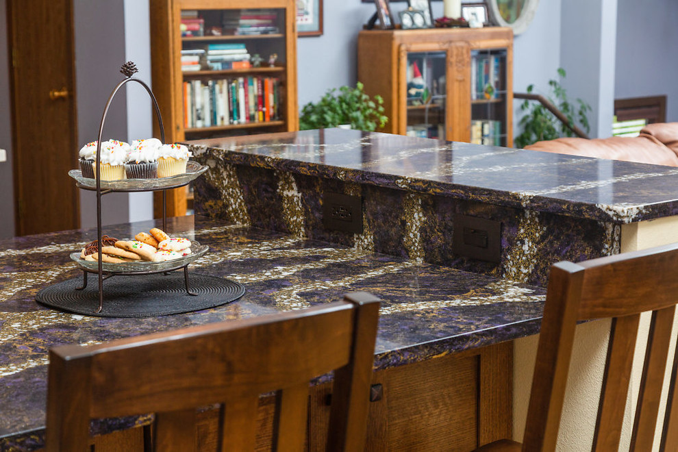 Open concept kitchen - mid-sized transitional l-shaped open concept kitchen idea with recessed-panel cabinets, dark wood cabinets, quartz countertops, white backsplash, subway tile backsplash, stainless steel appliances and an island
