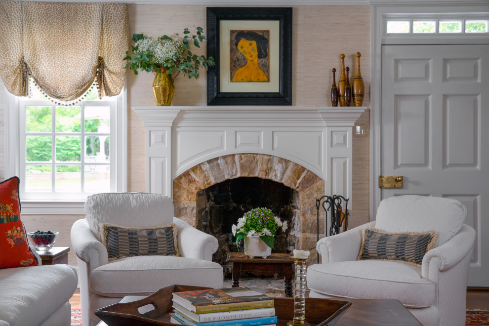 Family room - large traditional open concept dark wood floor, brown floor, exposed beam and wallpaper family room idea in Philadelphia with beige walls, a stone fireplace and a concealed tv