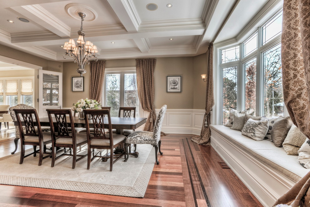 This is an example of a large contemporary separate dining room in Toronto with beige walls, medium hardwood floors, no fireplace and brown floor.