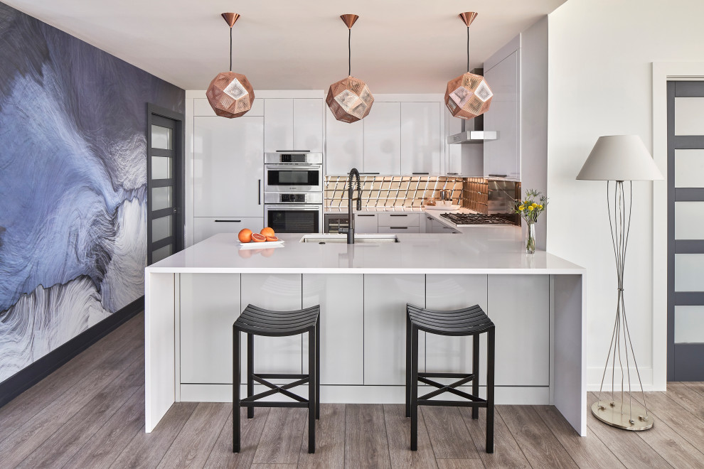 Example of a mid-sized trendy u-shaped vinyl floor and gray floor open concept kitchen design in Charlotte with an undermount sink, flat-panel cabinets, white cabinets, quartz countertops, metallic backsplash, glass tile backsplash, stainless steel appliances, a peninsula and white countertops