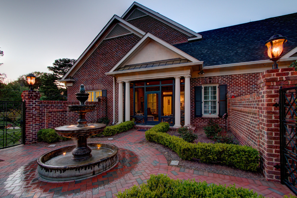 Inspiration for a large traditional two-storey brick red exterior in Charlotte with a hip roof.