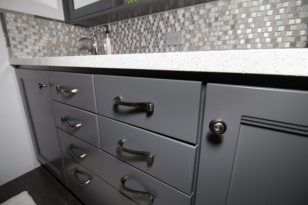 Example of a small transitional master porcelain tile porcelain tile home design design with recessed-panel cabinets, gray cabinets, a two-piece toilet, gray walls, an undermount sink and quartz countertops