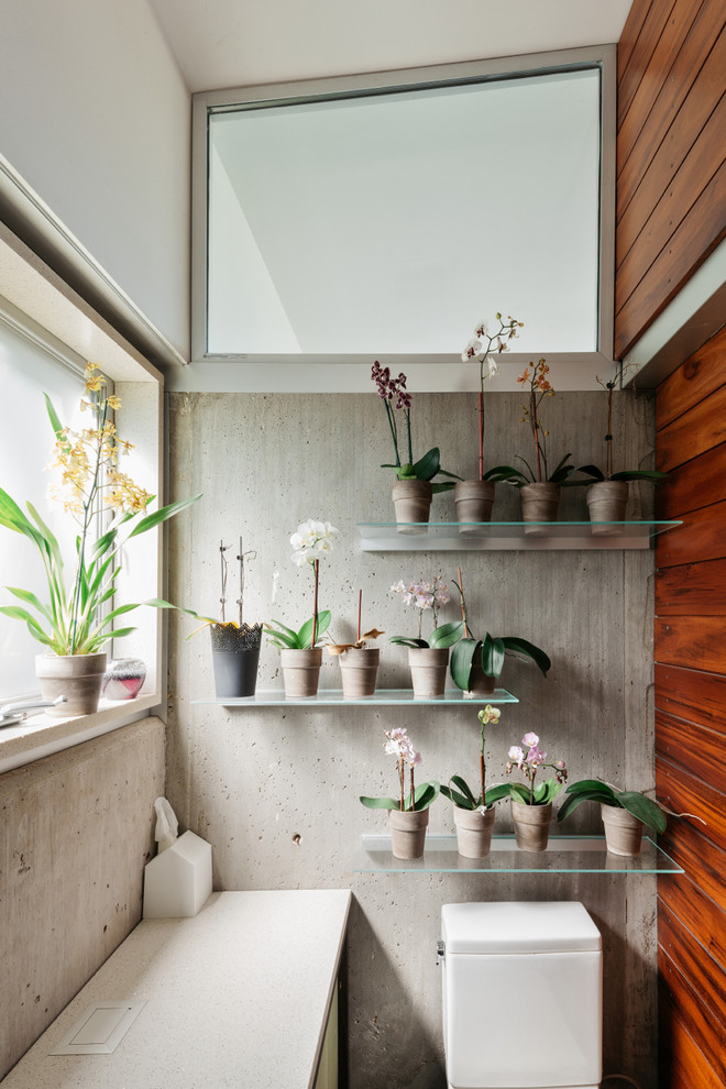 Small urban bathroom photo in Houston with a two-piece toilet and gray walls