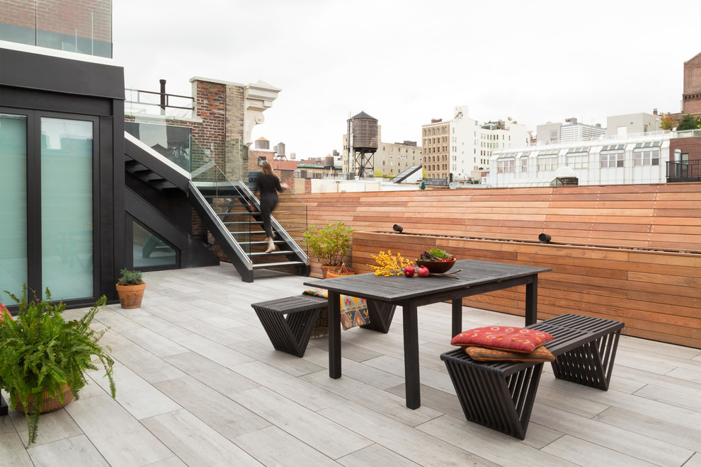 Design ideas for an industrial rooftop and rooftop deck in New York with no cover.