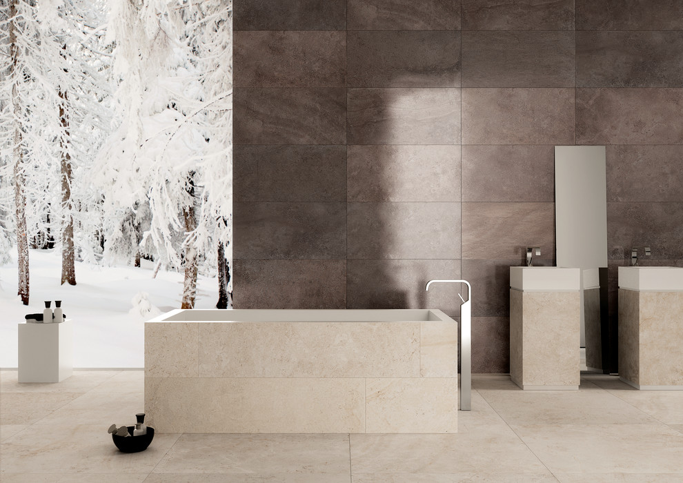 Design ideas for a contemporary bathroom in Perth with brown walls, porcelain floors, beige cabinets, a freestanding tub, beige tile, porcelain tile and a pedestal sink.