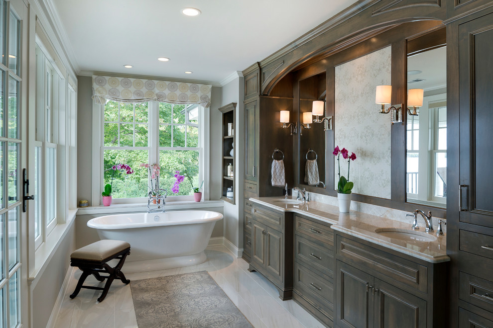 Inspiration for a mid-sized traditional master bathroom in Minneapolis with louvered cabinets, dark wood cabinets, a two-piece toilet, beige walls, porcelain floors, a vessel sink, solid surface benchtops, beige floor and beige benchtops.