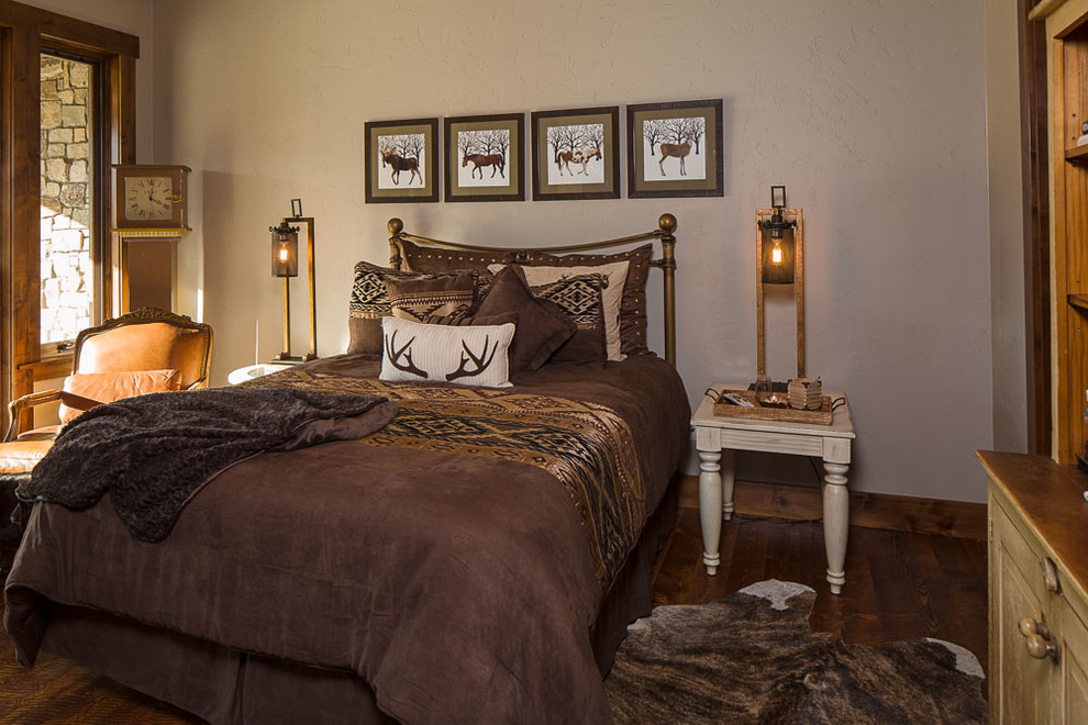 Inspiration for a mid-sized rustic guest dark wood floor bedroom remodel with beige walls and no fireplace