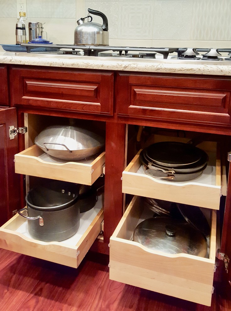 Inspiration for a large transitional medium tone wood floor eat-in kitchen remodel with raised-panel cabinets, medium tone wood cabinets, granite countertops, beige backsplash, ceramic backsplash, stainless steel appliances and an island