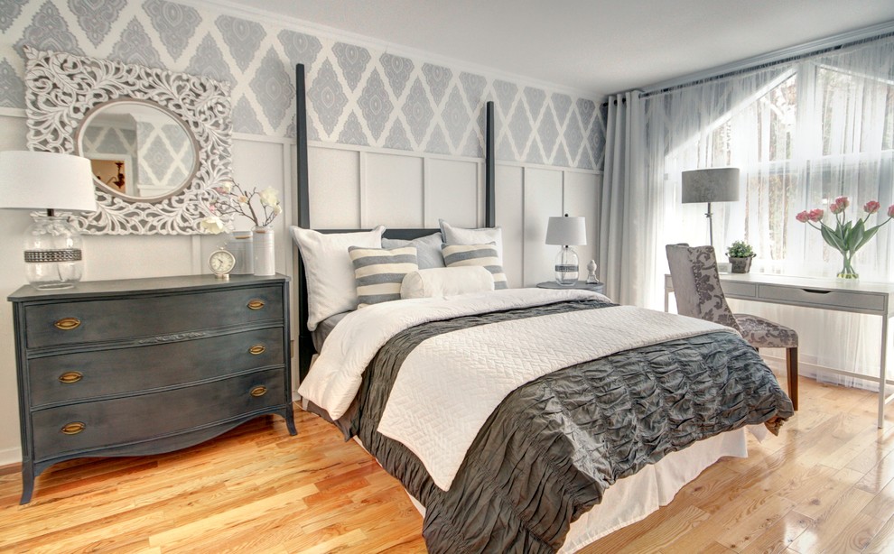 Photo of a mid-sized traditional guest bedroom in Montreal with grey walls and light hardwood floors.